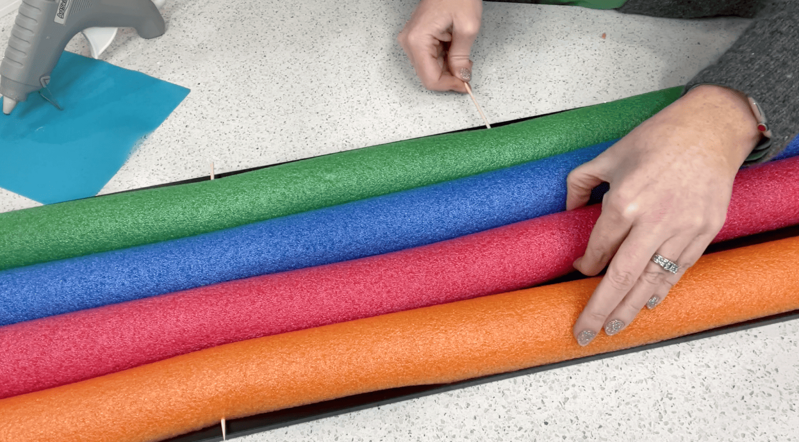 Lindsay adding multiple bamboo skewers to ensure that her pool noodles are secure