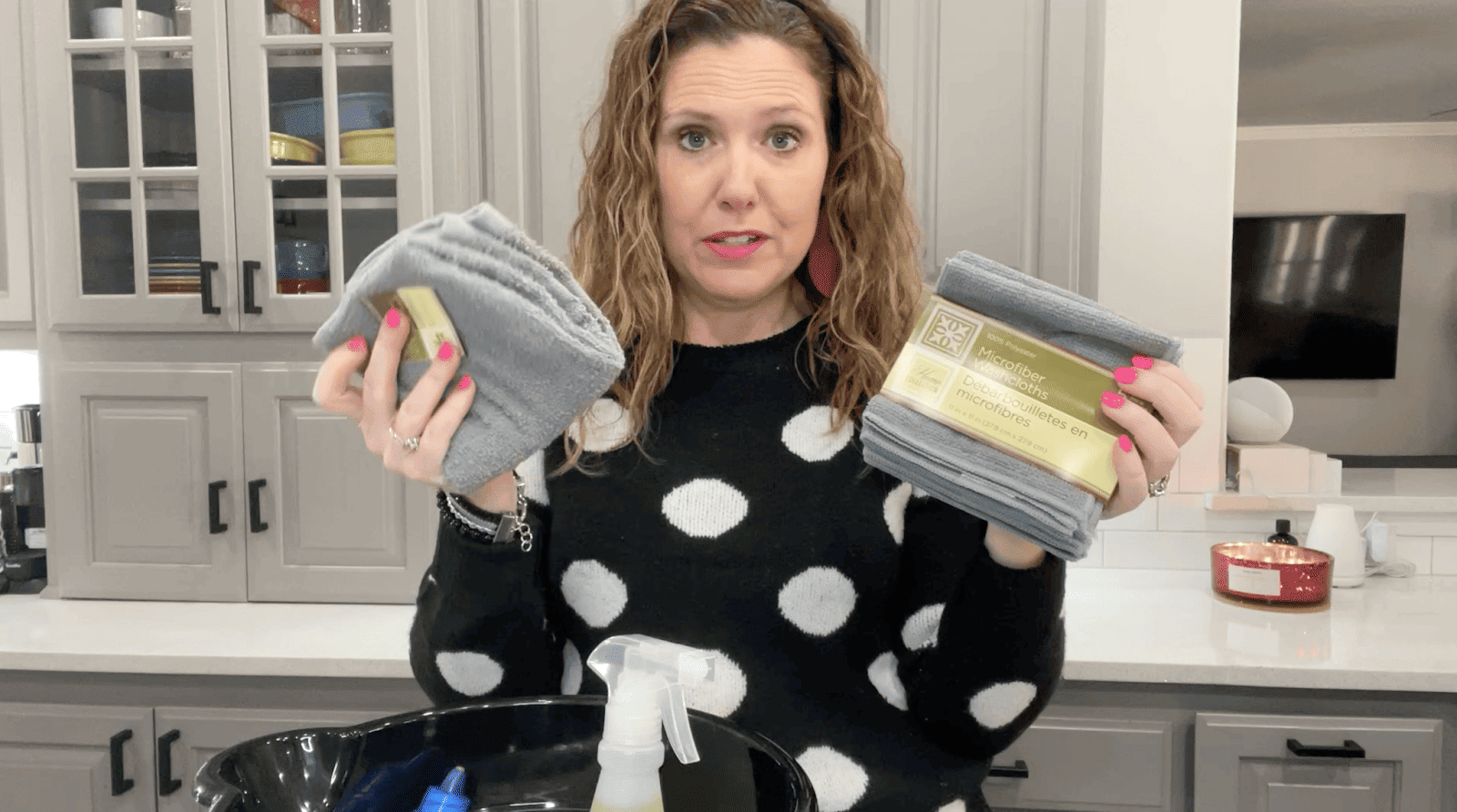 Lindsay holding up microfiber cloths and a towel